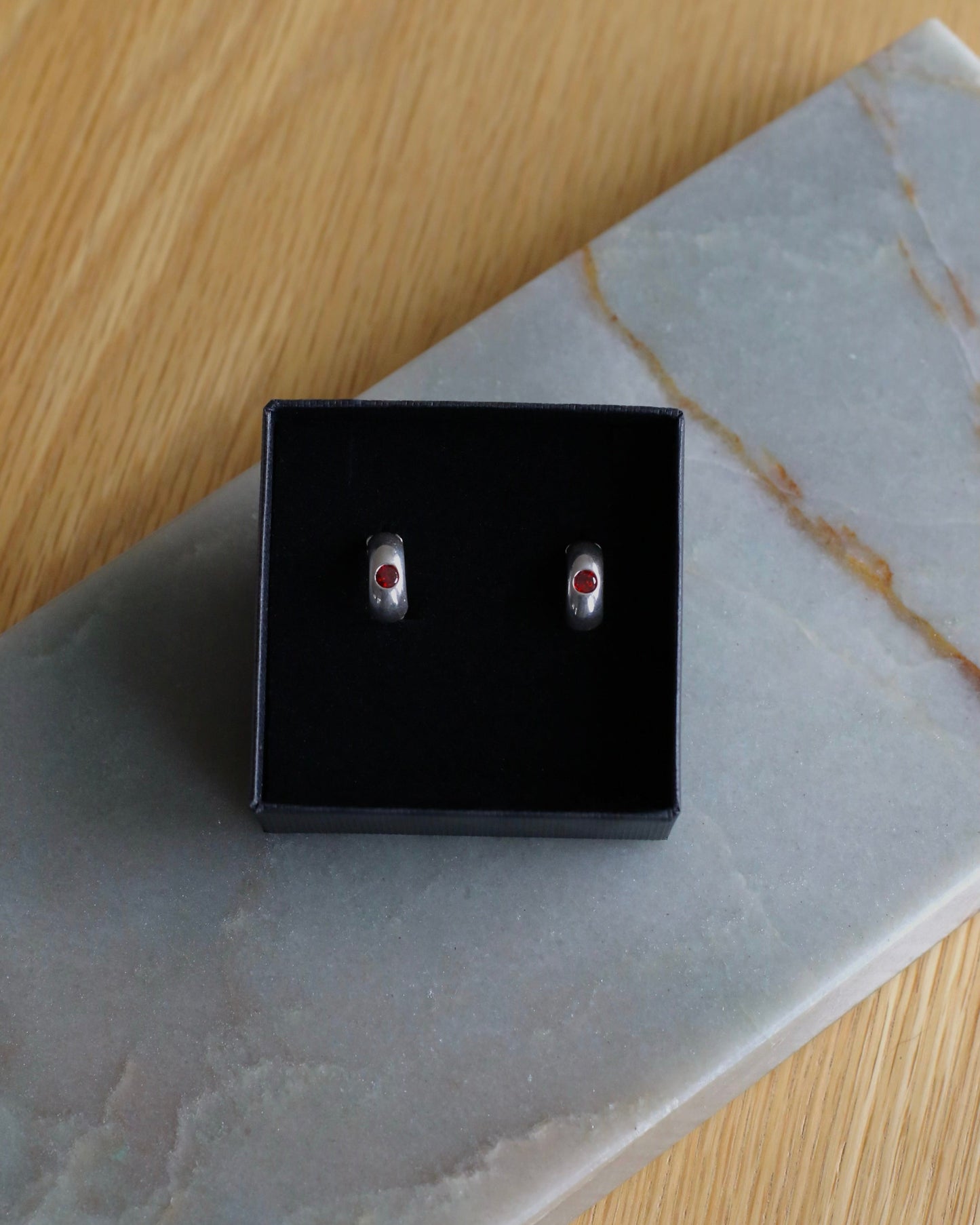 Silver Huggies With Red Cubic Zirconia